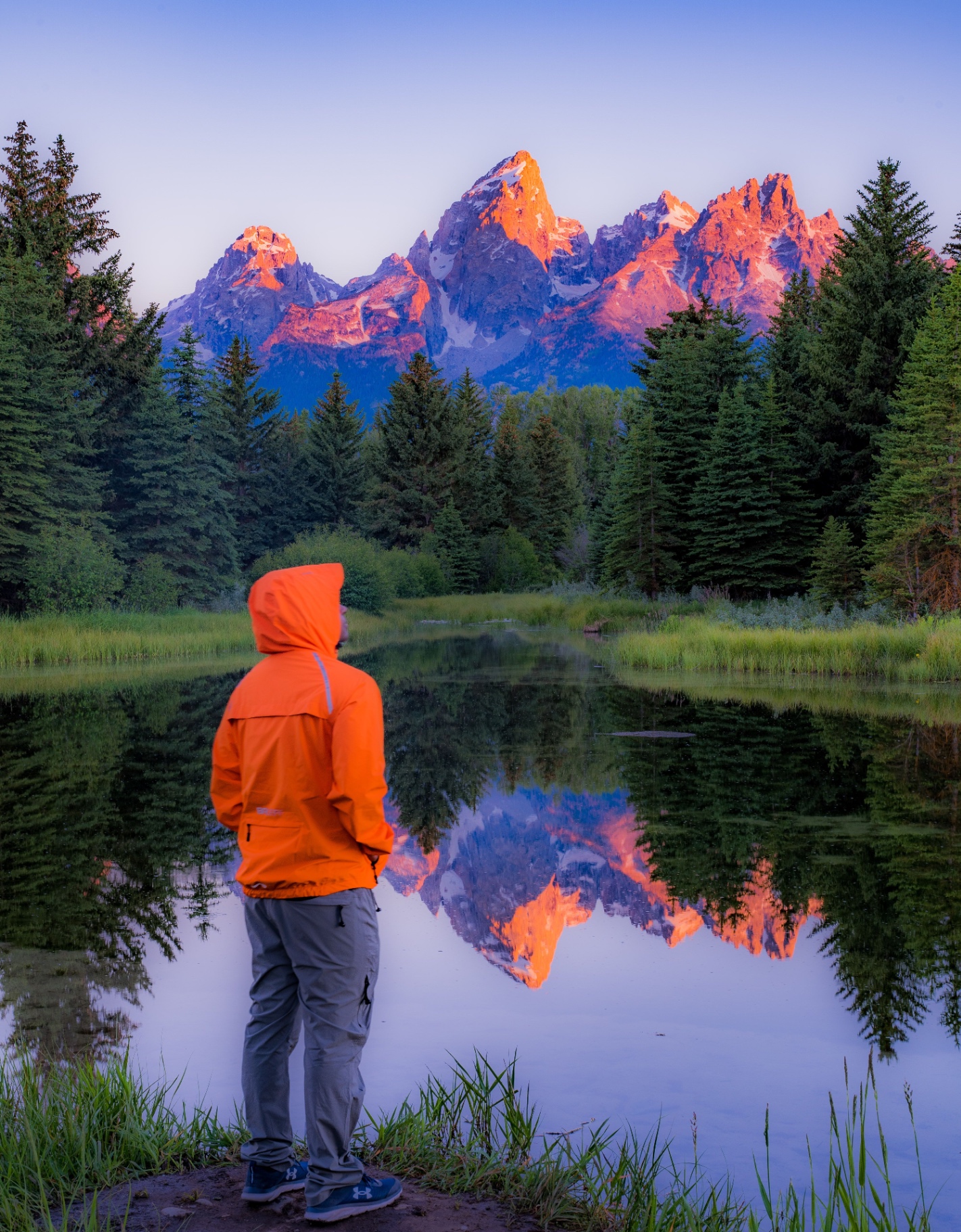Grand Teton peaks at sunrise reflected on a still pond